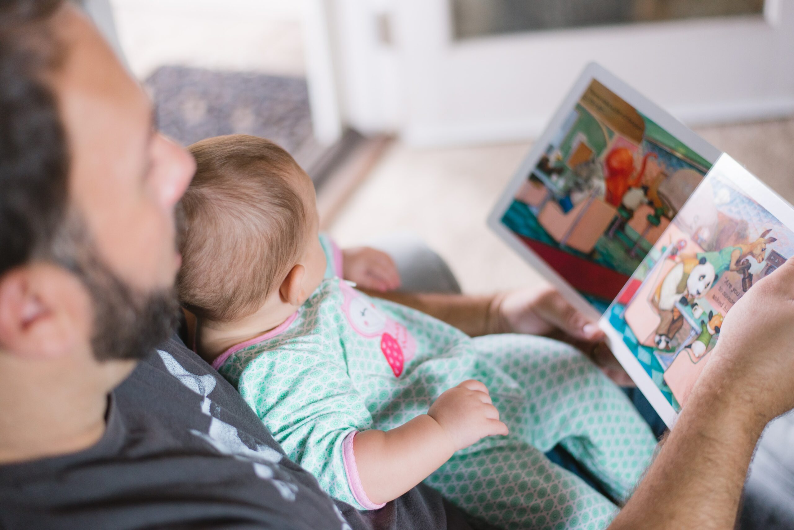 dad reading with a baby