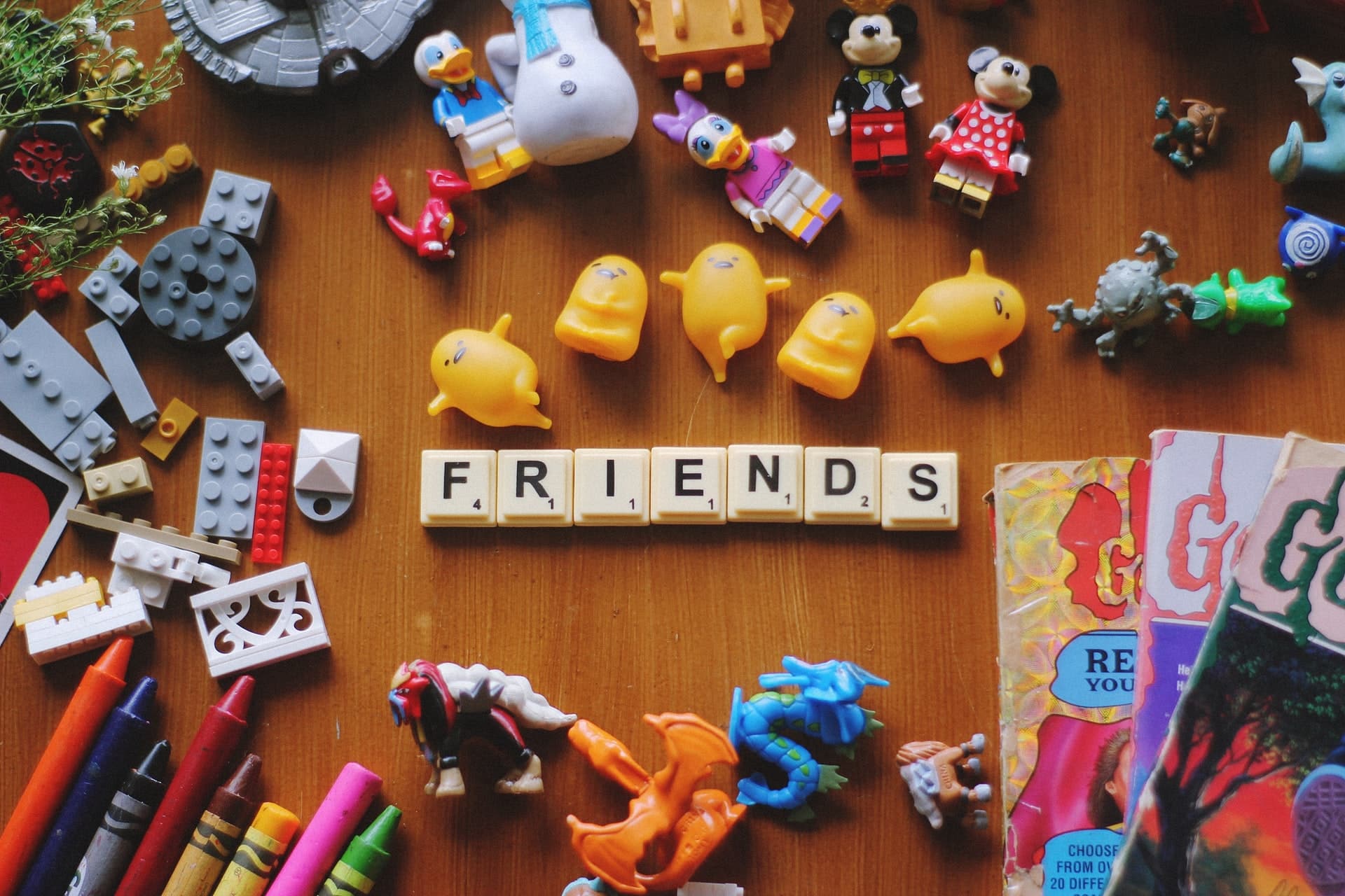 word friends put with playing tiles with toys around