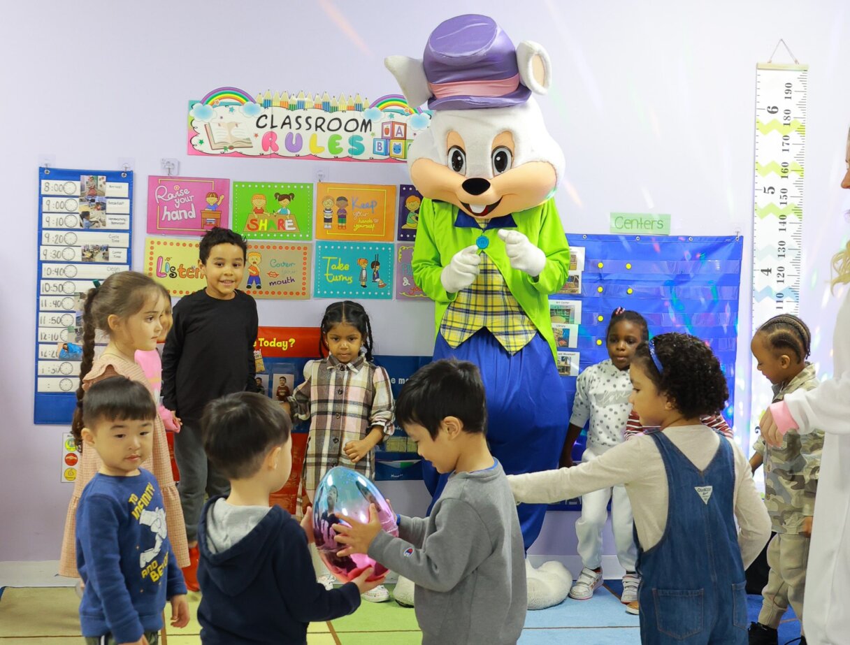 Children engaging with an Easter Bunny during festive activities at Little Scholars Daycare.