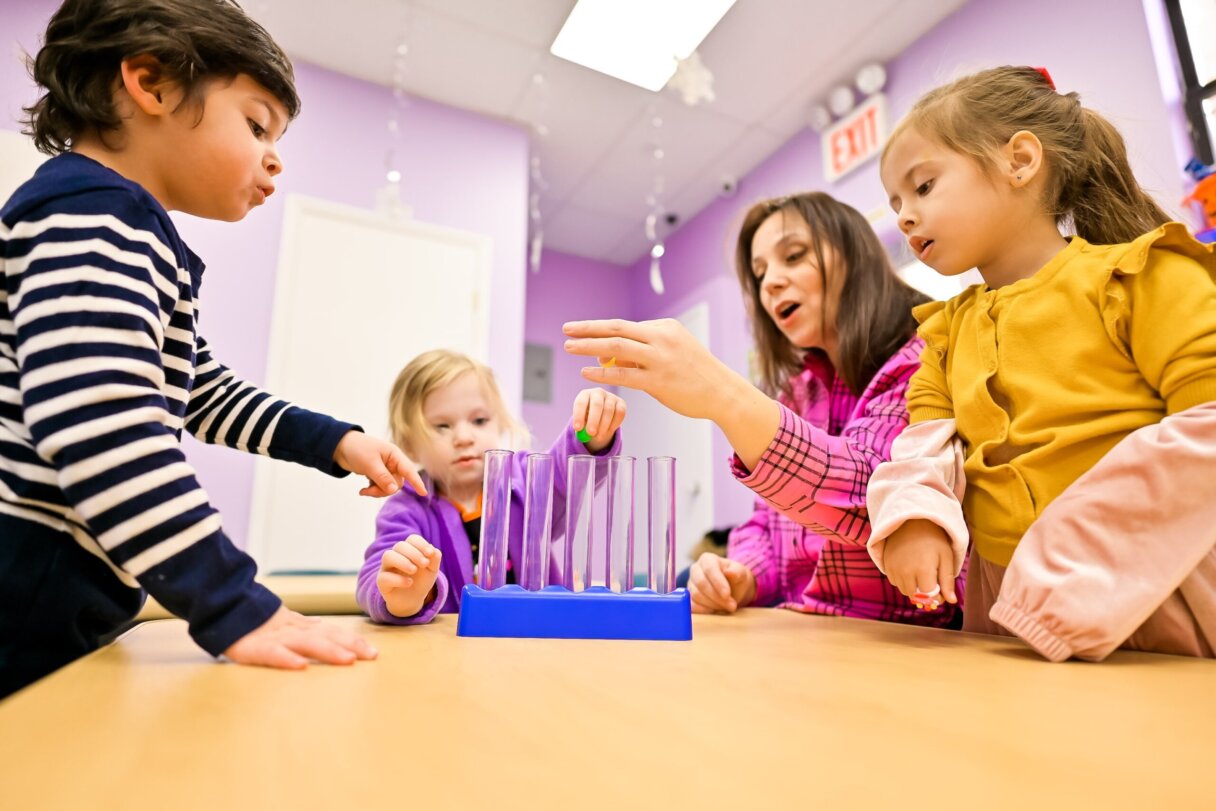 Children engaged in a science experiment at Little Scholars Daycare, illustrating the hands-on approach to early childhood education.